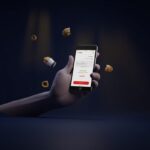 Modern 3D fintech illustration of a hand-held smartphone with QRIS payment screen and small everyday